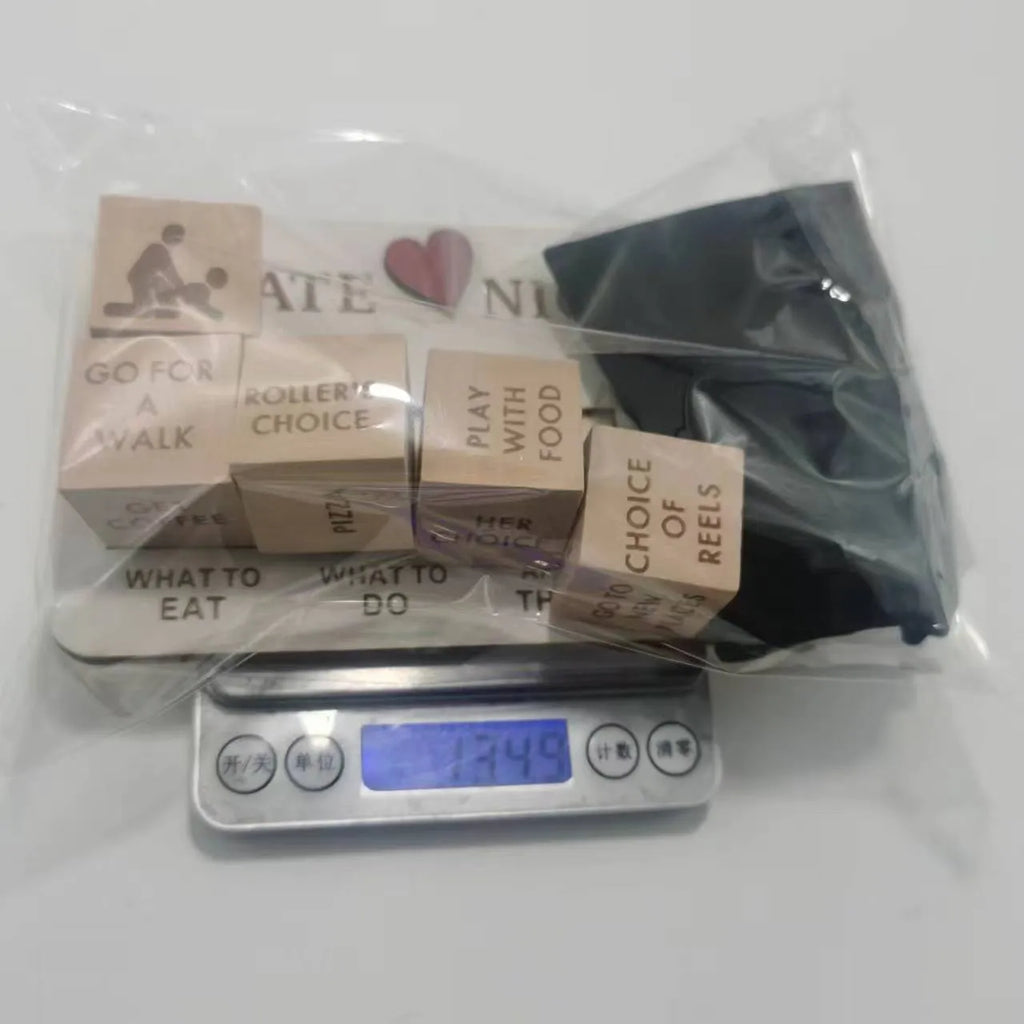 Wooden date night dice set with five natural wood dice on a rectangular planner board next to a black storage bag.