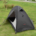 Black single person double account tent with aluminium poles pitched outdoors.