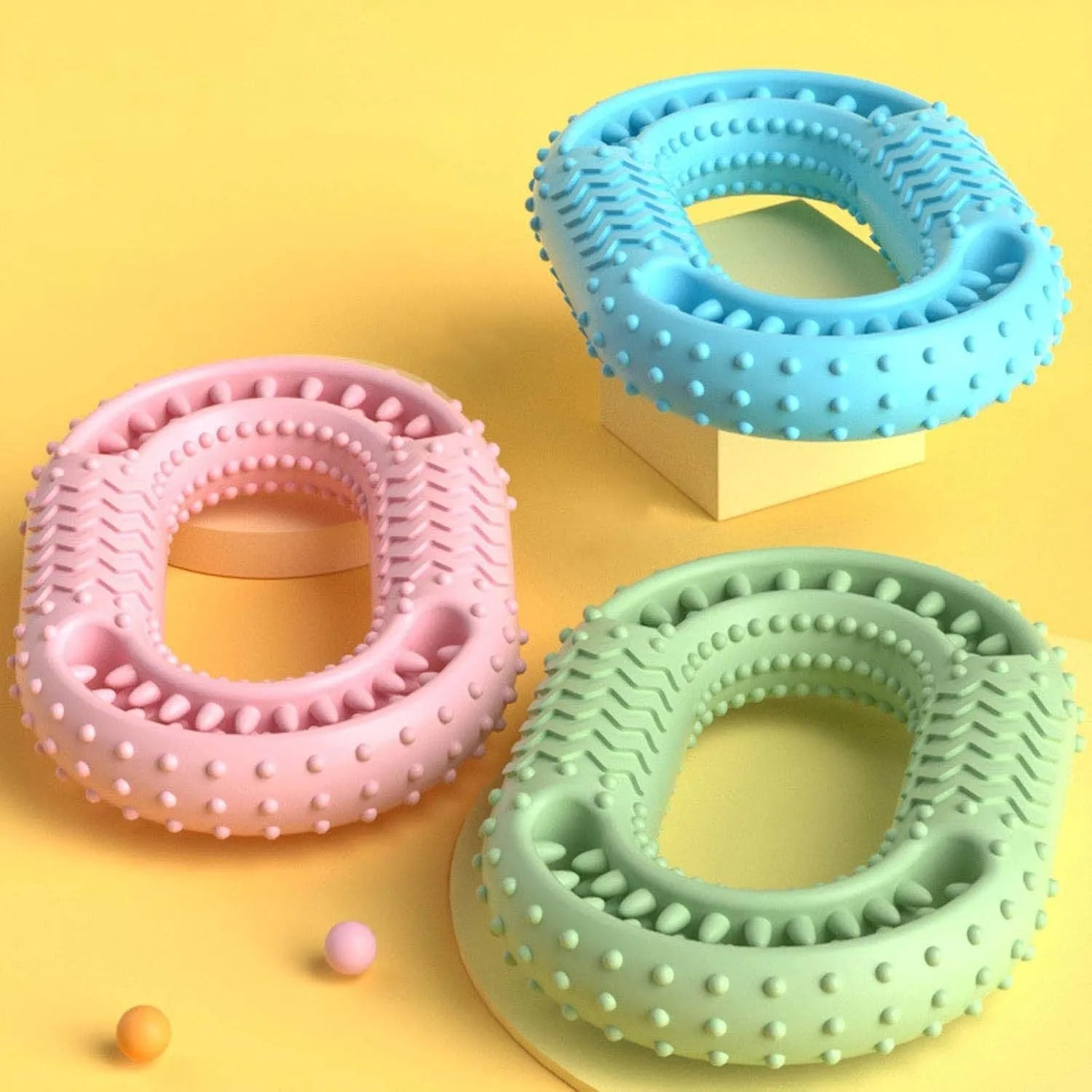 Blue, green, and pink heavy-duty O-ring shaped dog chew toy for aggressive chewers.