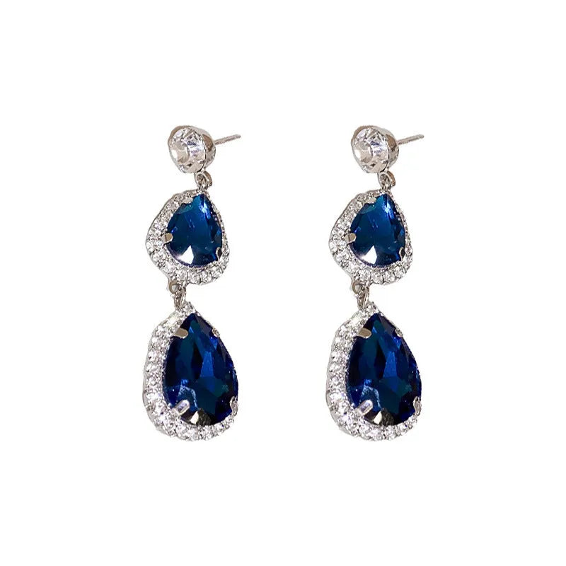 Silver needle water drop earrings and necklace set with blue zircon pendant on display