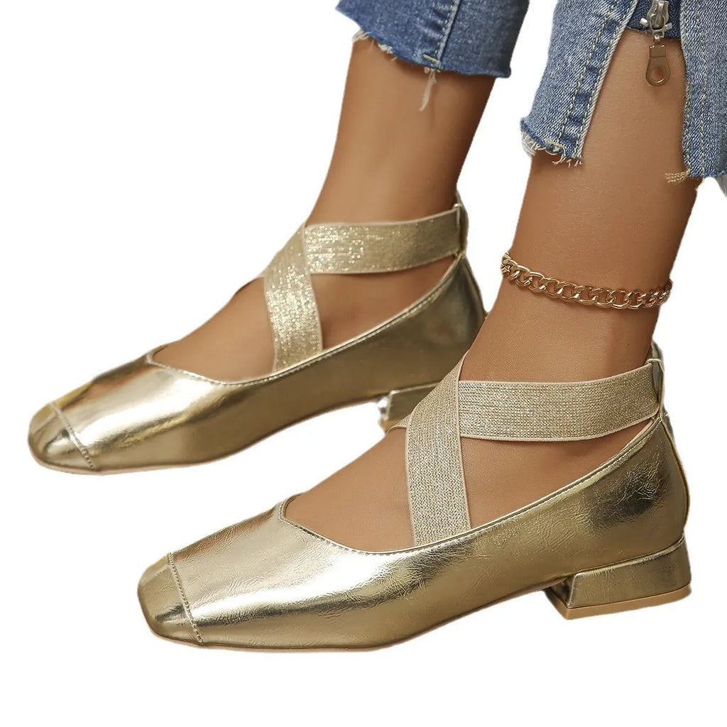 Gold French evening style slip-on pumps with a skirted collar and square toe on a white background.