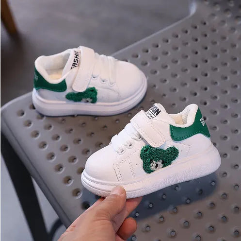 Baby Bear cartoon pattern children's sneakers in green, shown on a white background.