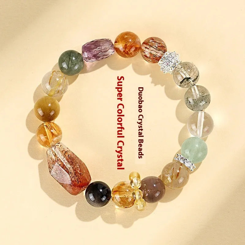 Close-up of a women's black and gold bracelet with natural Super Seven Duobao crystal beads.