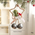 Iron Christmas bell ornament in gold hanging on a Christmas tree branch
