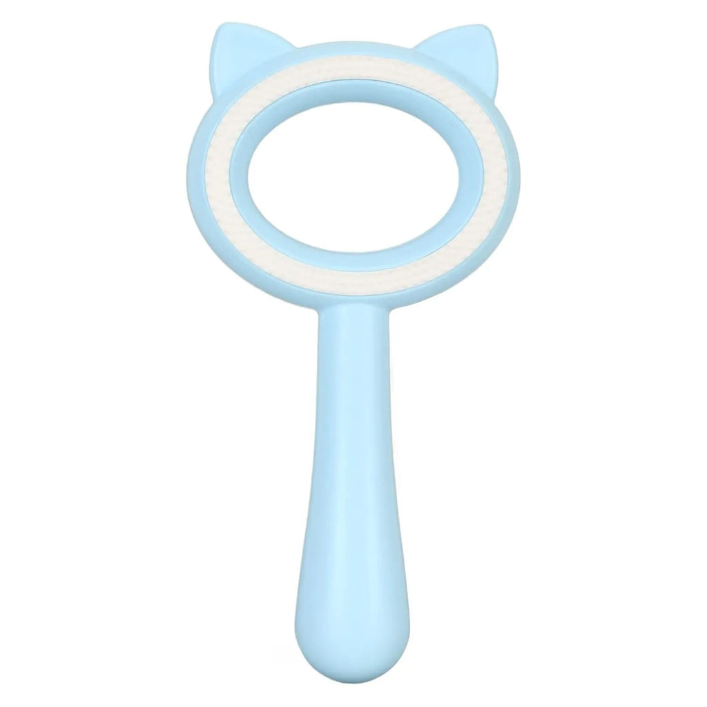 Blue and white double-sided pet grooming brush with ergonomic handle on a table