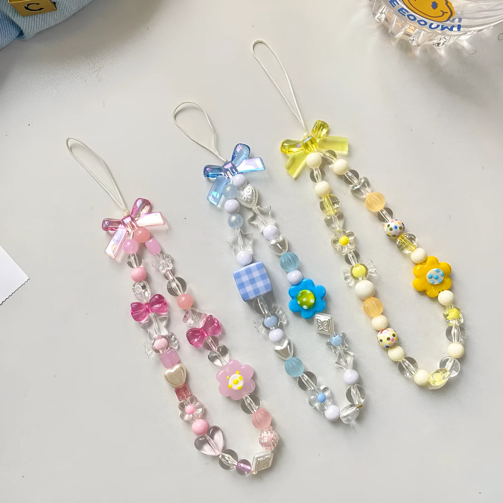 Blue floral beaded mobile phone lanyard with an adjustable hand rope.