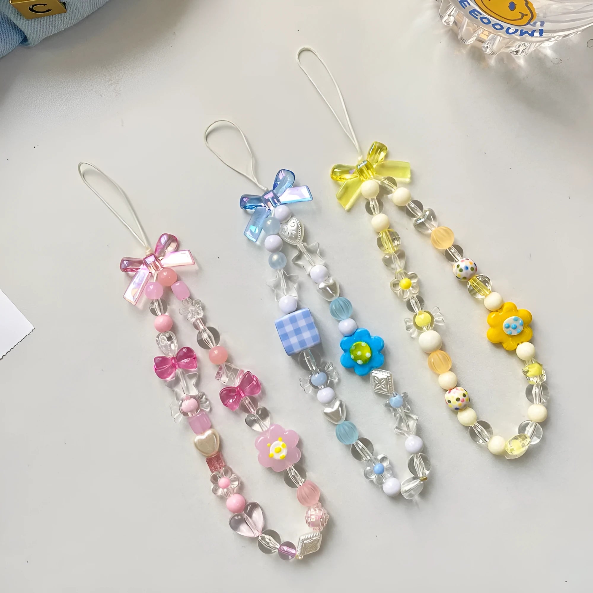 Blue floral beaded mobile phone lanyard with an adjustable hand rope.