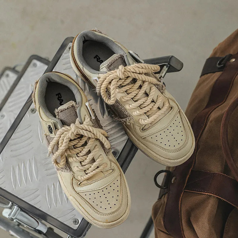 Beige low-top skateboard shoes with vintage patch design and rubber sole
