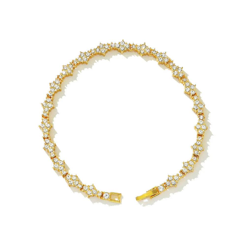 Flower-shaped cross tennis chain bracelet in gold alloy with diamond geometry pattern close-up