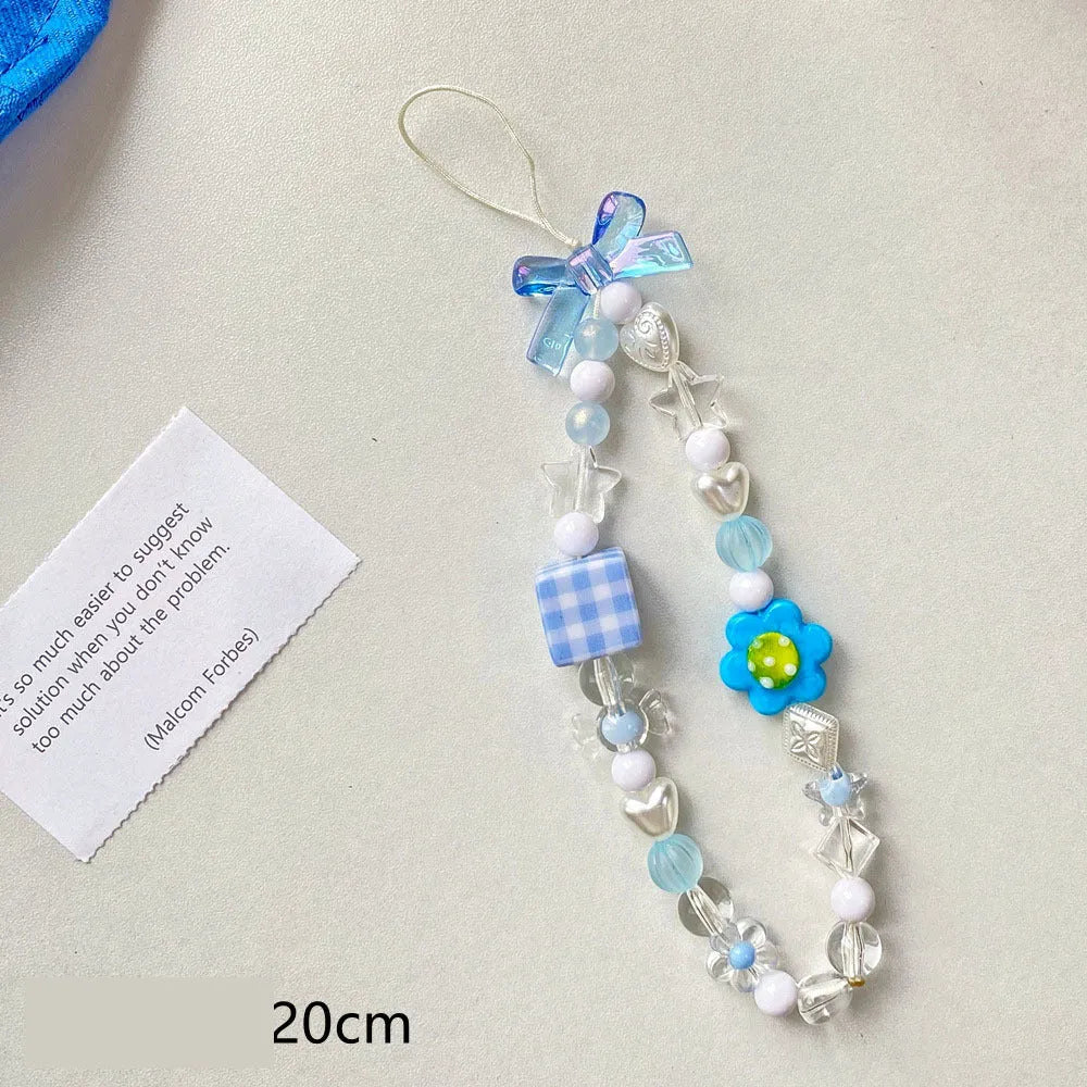 Blue floral beaded mobile phone lanyard with an adjustable hand rope.