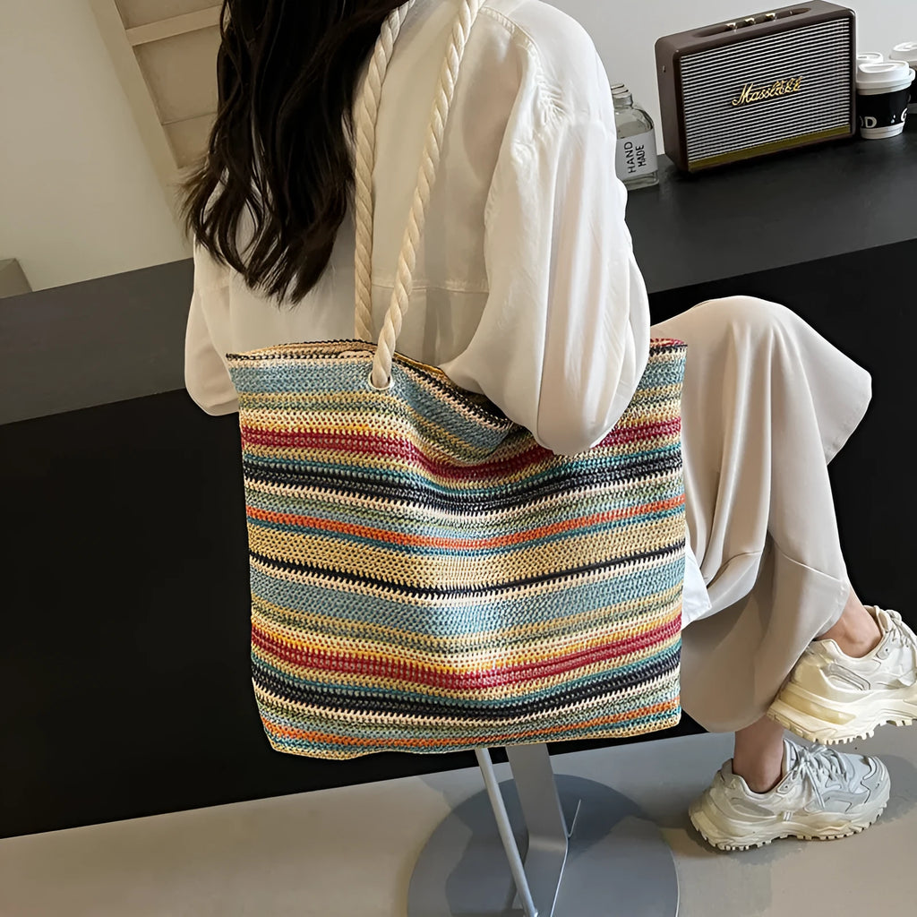 Blue woven nylon shoulder bag with single strap and straw texture.