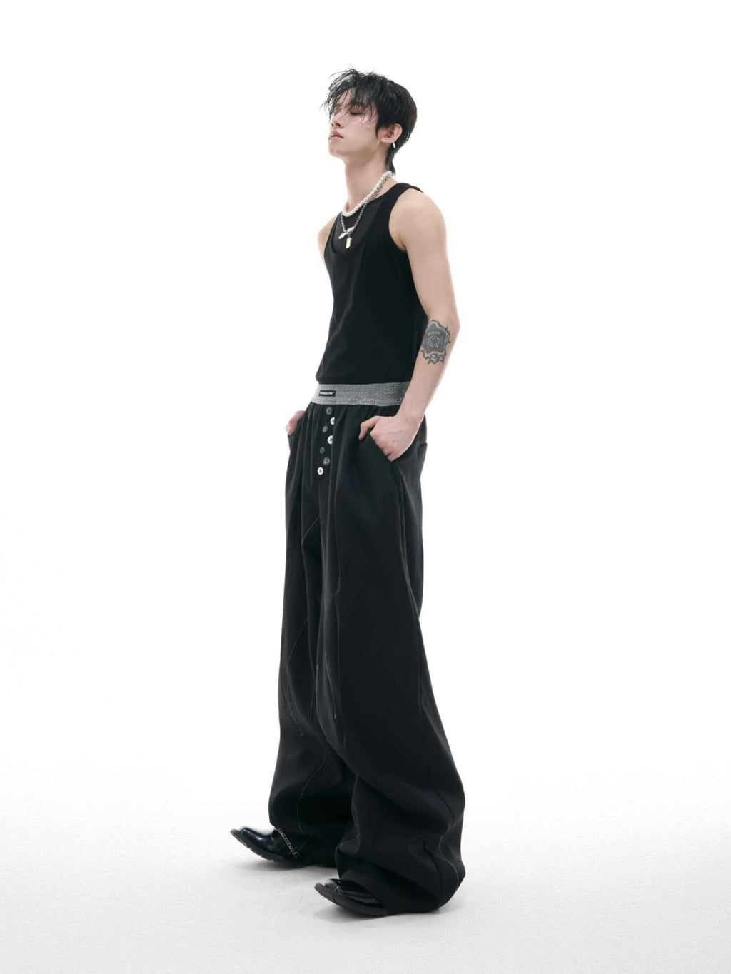 A pair of high-waisted straight-leg casual trousers in a black polyester-cotton blend with a button fly and open hem.