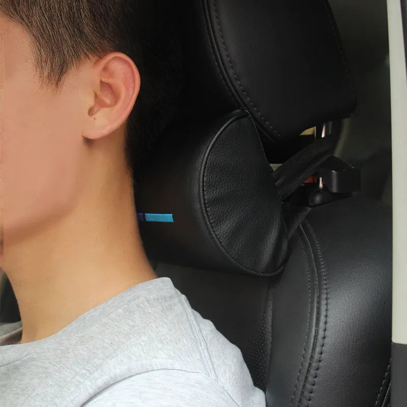 Black cotton car seat neck pillow for travel support on a car headrest