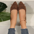 Women's blue knitted flat loafers with a bow and pointed toe on a rubber sole.