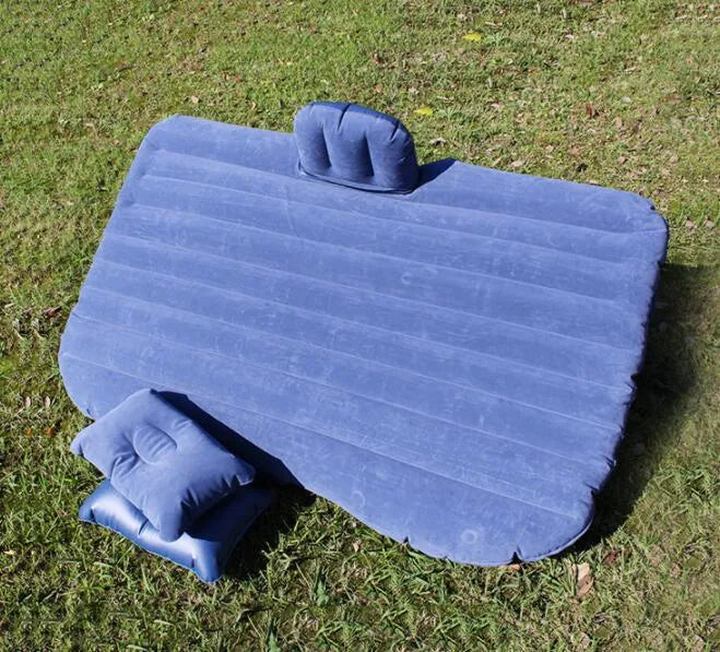 Black inflatable car bed with flocked material laid out in a five-seater vehicle boot.