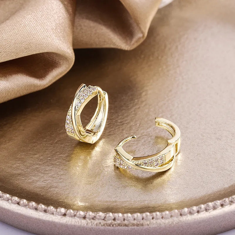 Geometric shaped women's earrings with 14K yellow gold plating and zircon stone details on a copper base.