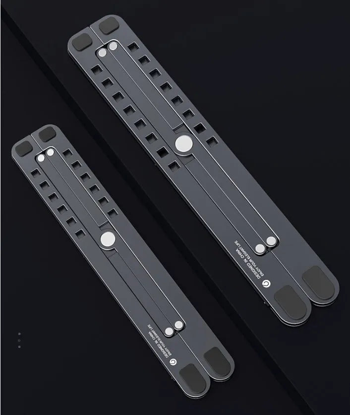 Aluminium foldable laptop stand in silver colour, shown elevated with a laptop on top