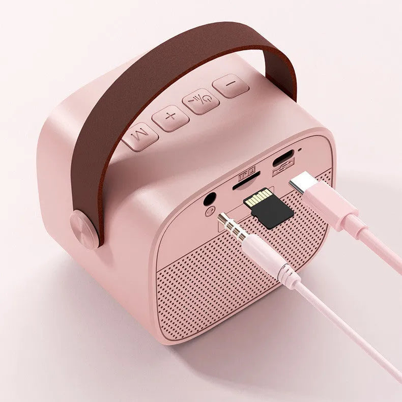 Compact blue, pink or white portable Bluetooth speaker with built-in microphone on a surface.