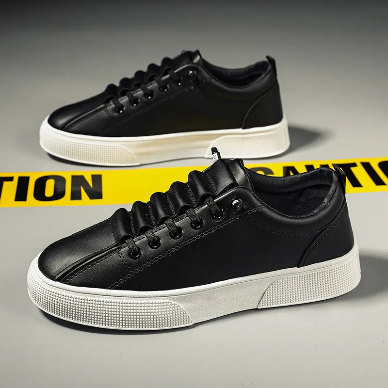 Men's black and white low top sports shoes with mesh panels and synthetic leather upper.