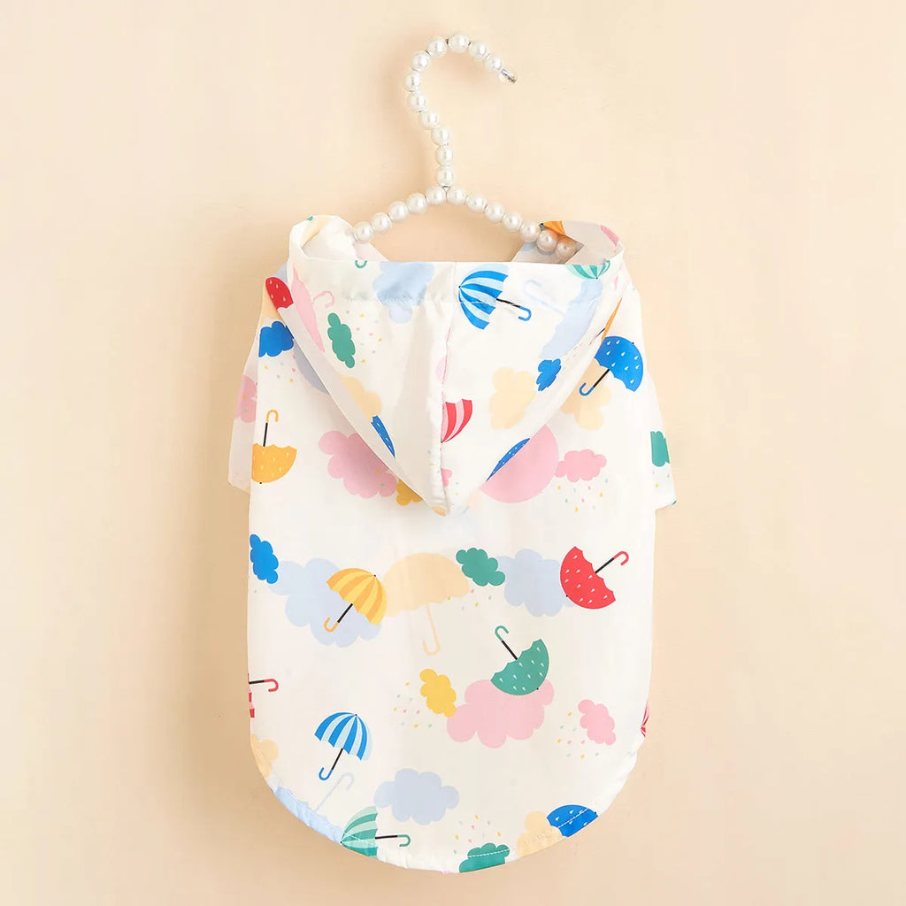 Colourful cartoon umbrella print dog raincoat in polyester, showing sizes XS, S, M, L, XL.