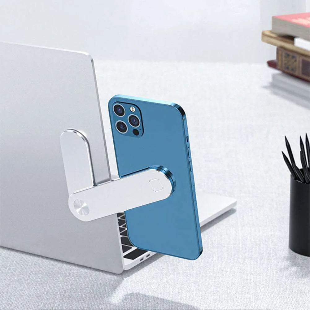 Black aluminium laptop phone holder with magnetic clip attached to laptop edge holding a smartphone