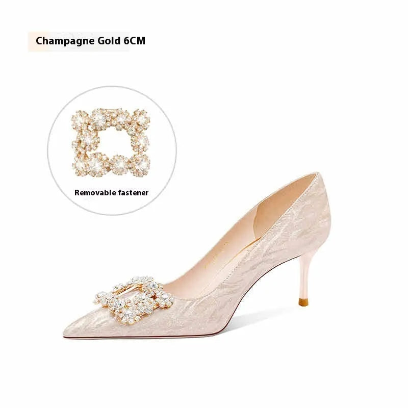 Champagne gold pointed-toe stiletto pumps with rhinestone details on the heel.