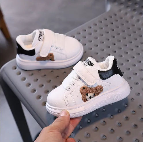 Baby Bear cartoon pattern children's sneakers in green, shown on a white background.