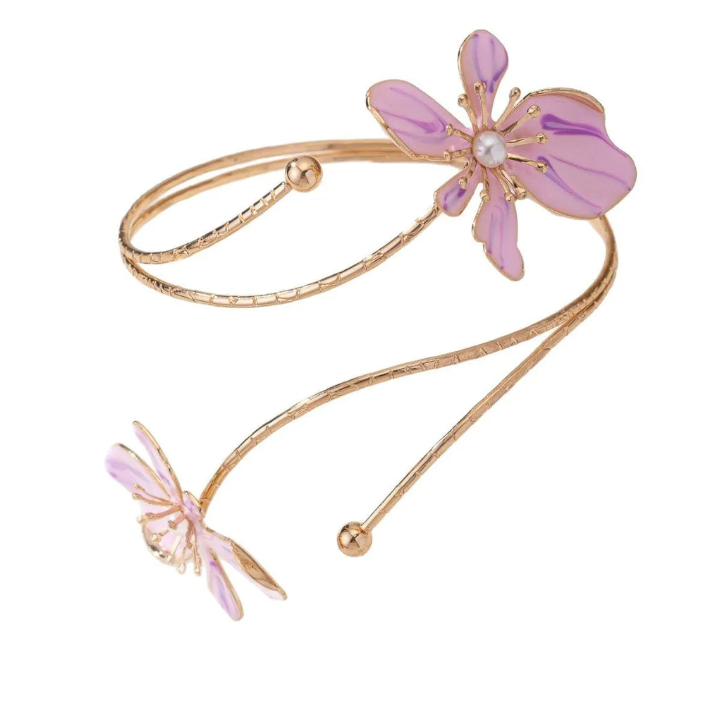 Close-up of a pink alloy armband with a hollow lines pattern, shown on a wrist.