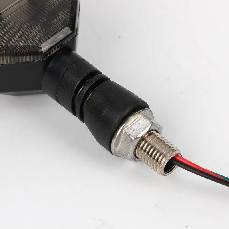 Arrow-shaped LED motorcycle turn signal light with ABS plastic housing for 12V systems.