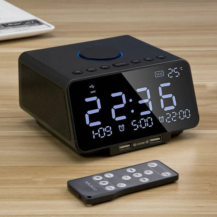Black and white wireless alarm clock Bluetooth speaker with control buttons on top.