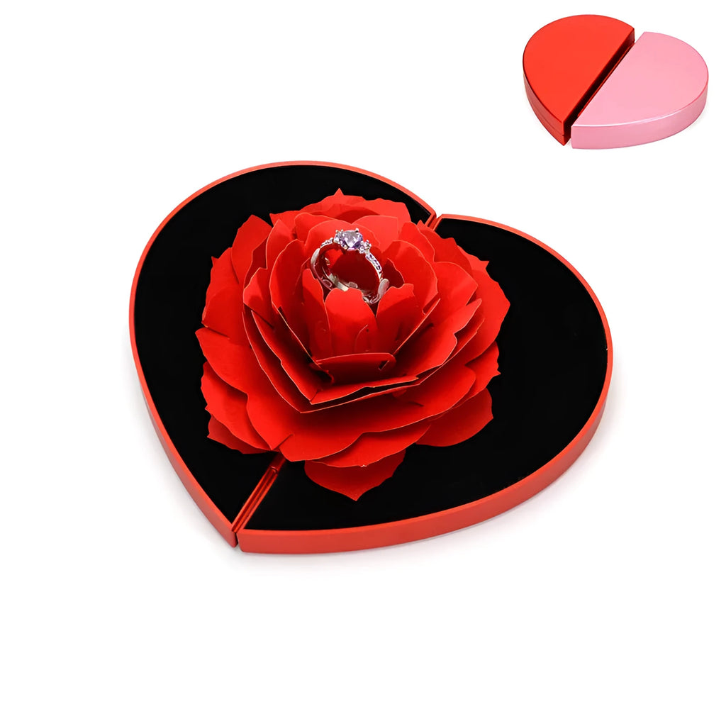 Red plastic heart-shaped rotating ring box with rose decoration inside white storage case