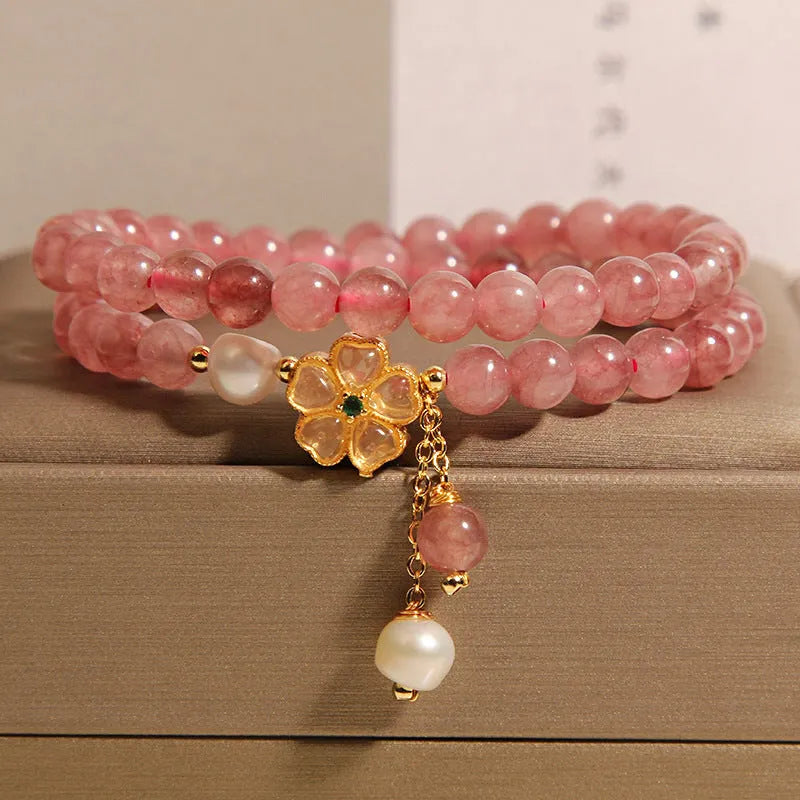 Double ring women's bracelet with strawberry quartz four-leaf clover charms and alloy gemstone details.