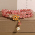 Double ring women's bracelet with strawberry quartz four-leaf clover charms and alloy gemstone details.