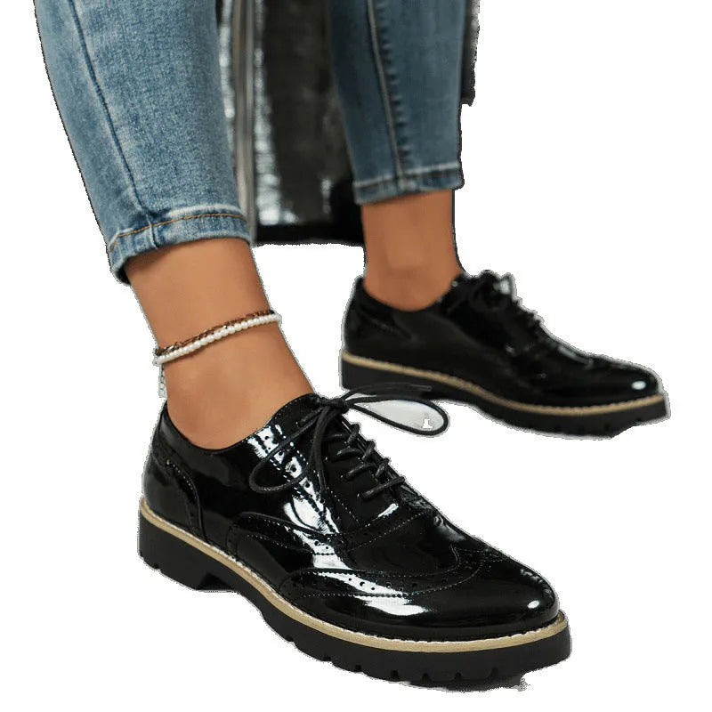 Women's black loafers with wedge heel and lace-up design, sequin detailing on round toe