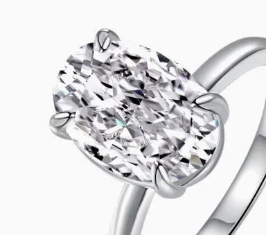 Women's oval ring with four-claw setting in gold or silver colour, 6x9mm gemstone