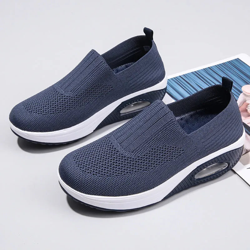 Women's beige casual running shoes with mesh upper and air cushion sole on a white background.