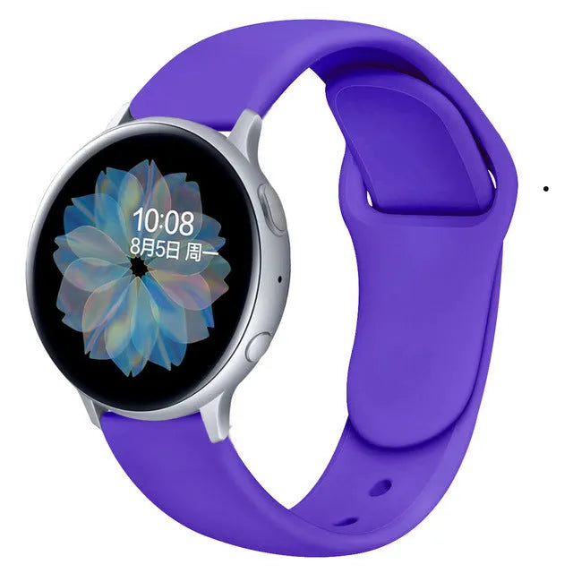 Samsung Galaxy Active 2 smartwatch with a purple silicone replacement strap featuring a reverse buckle clasp.