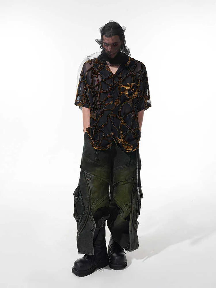 Man wearing a black and grey snake pattern short-sleeved translucent polyester shirt with a loose fit.
