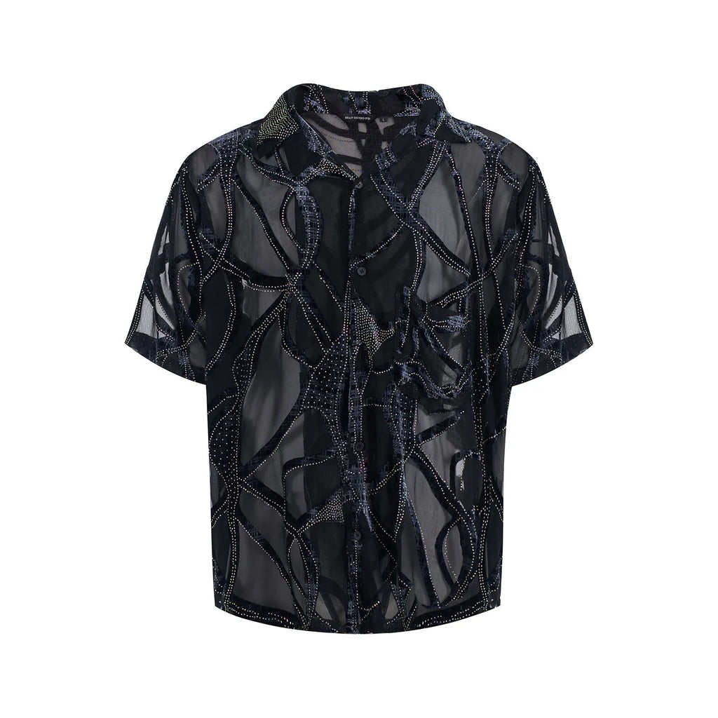 Man wearing a black and grey snake pattern short-sleeved translucent polyester shirt with a loose fit.