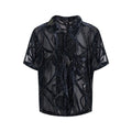 Man wearing a black and grey snake pattern short-sleeved translucent polyester shirt with a loose fit.