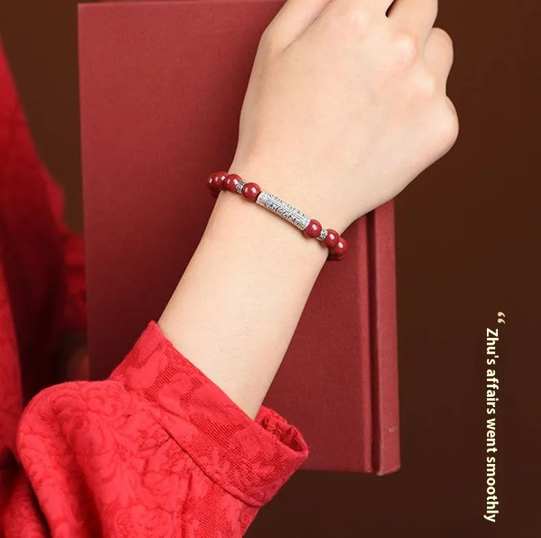 Handmade cinnabar sandstone bracelet in purple gold sand colour with 8mm beads on a wrist.