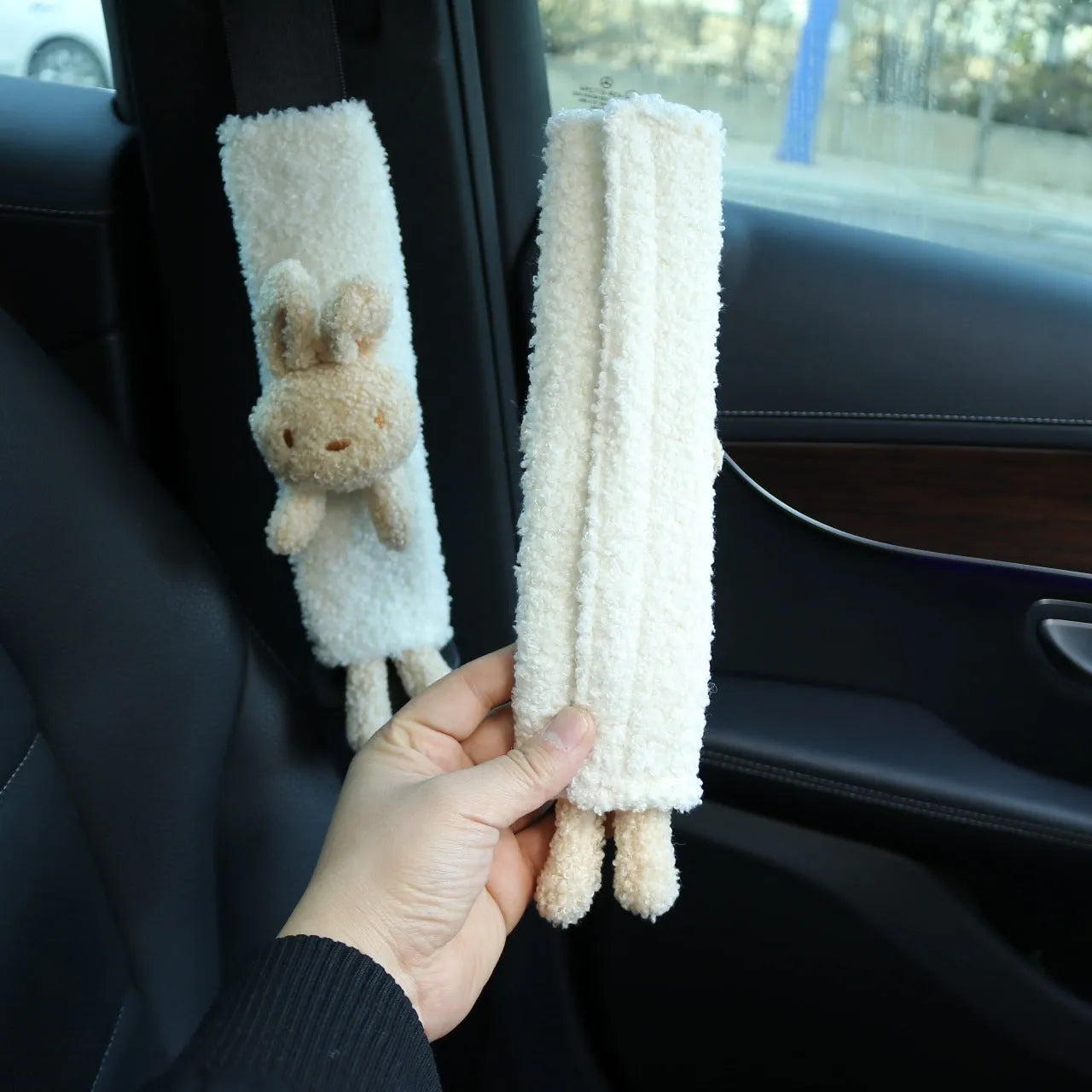Cartoon rabbit and bear designs on a soft lamb wool car seatbelt shoulder protector.
