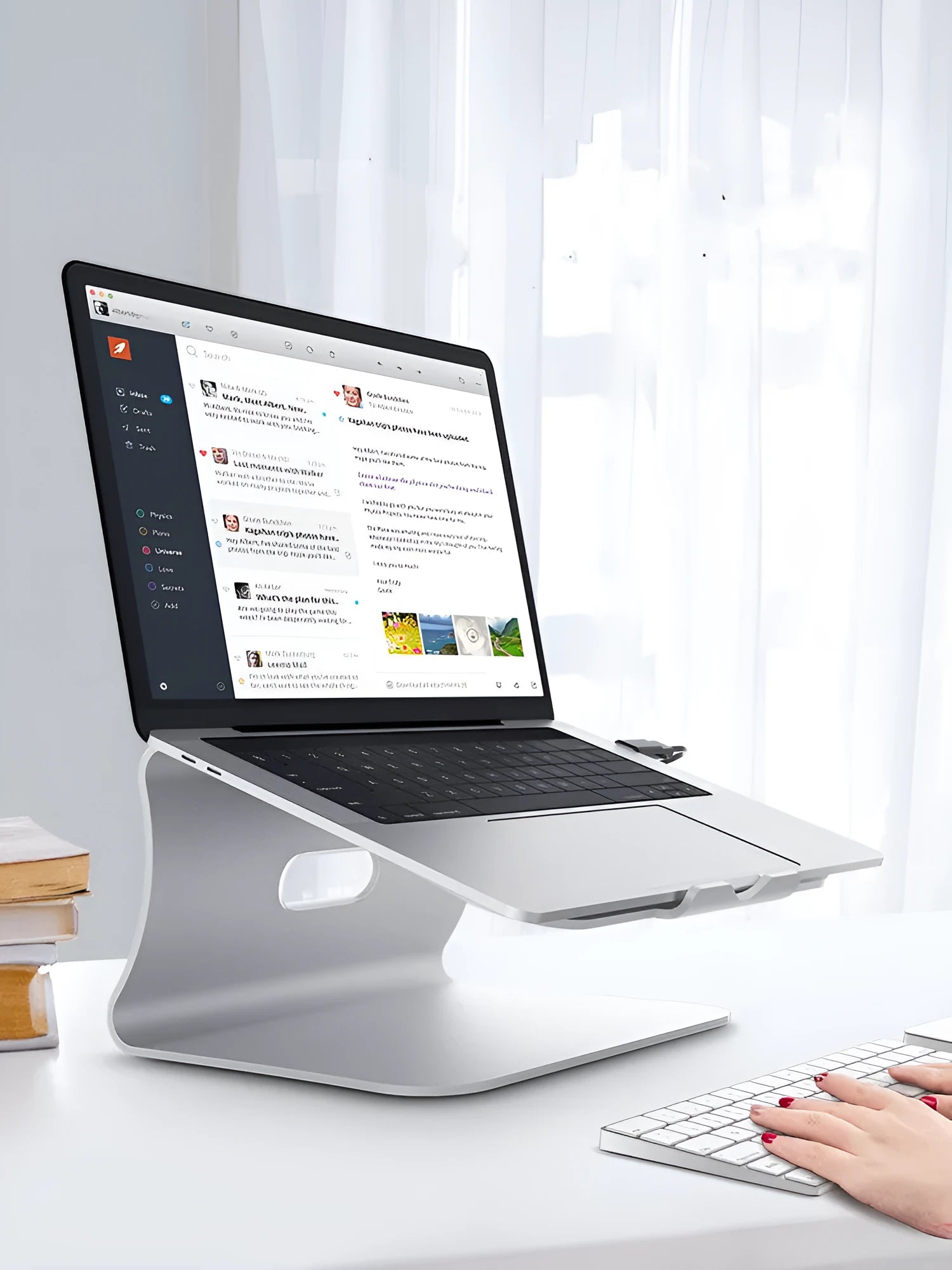 Aluminium laptop cooling bracket with rotary adjustment in silver or grey colour.