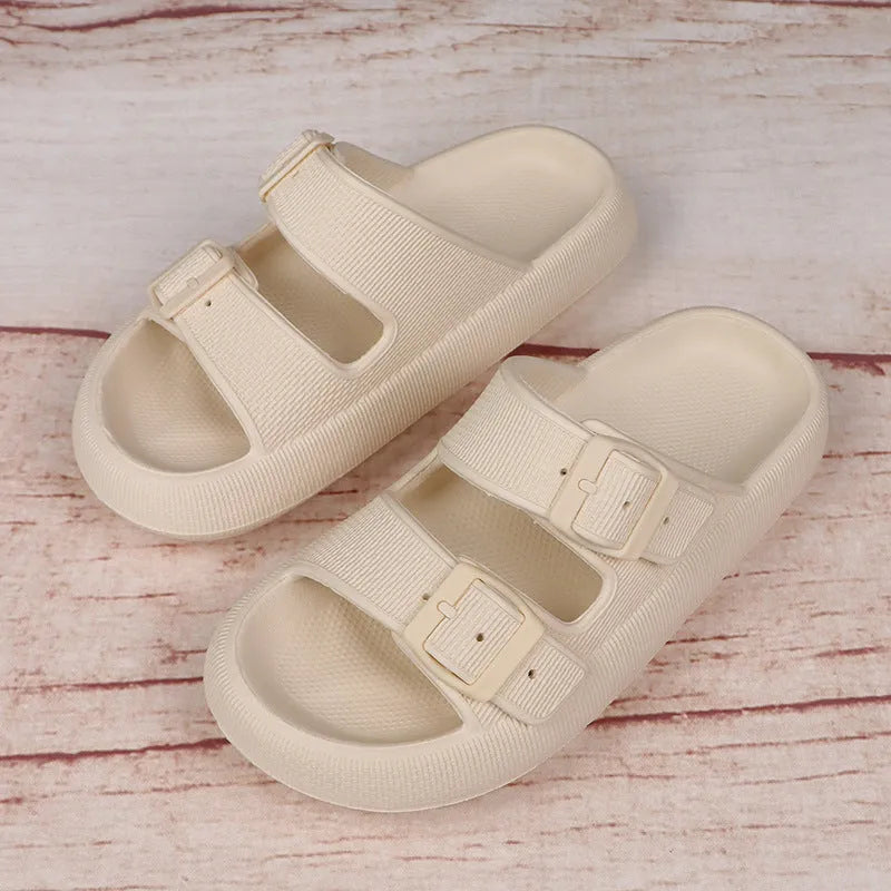 Women's beige platform slippers with buckle fastening and round toe on a flat surface