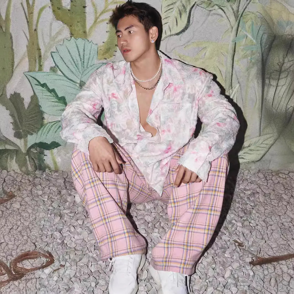 Pink embossed floral pattern long sleeve shirt laid flat, showing loose fit and textured design.