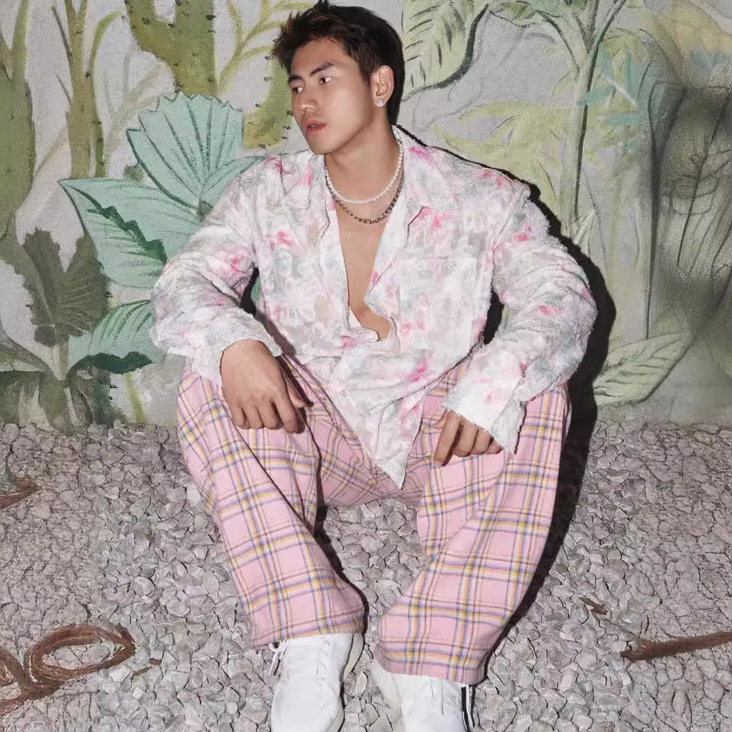 Pink embossed floral pattern long sleeve shirt laid flat, showing loose fit and textured design.
