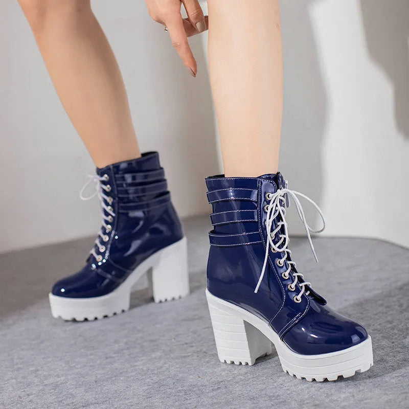 Women's black thick-heeled short boots with lace-up front and round toe on a rubber sole.