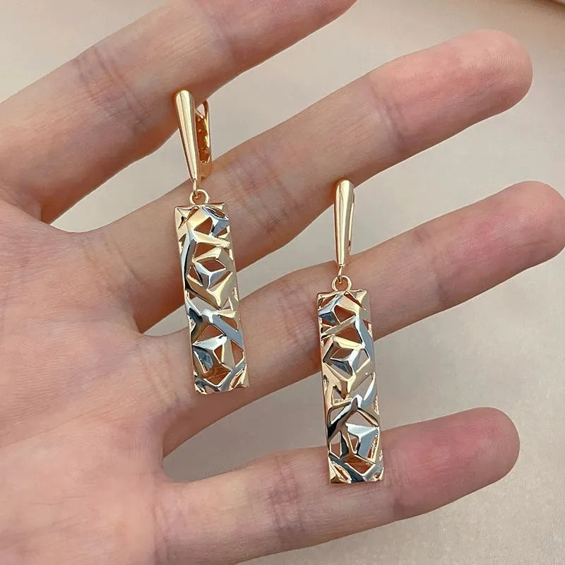 Rectangular two-tone hollow alloy stud earrings for women with electroplated finish.