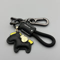 Handmade brown cowhide leather keychain with a zinc alloy pony belt buckle on a green flanelle rope.