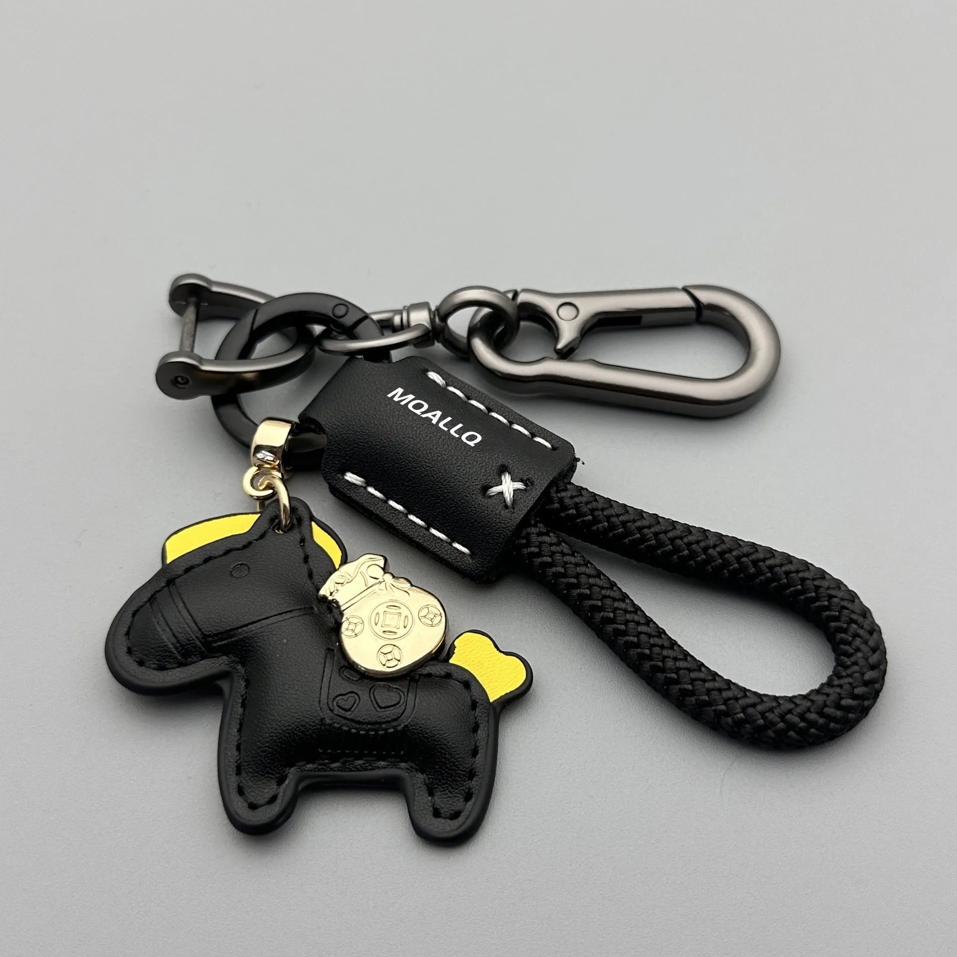 Handmade brown cowhide leather keychain with a zinc alloy pony belt buckle on a green flanelle rope.